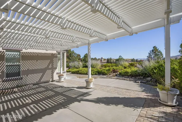 a view of a patio with table and chairs and potted plants
