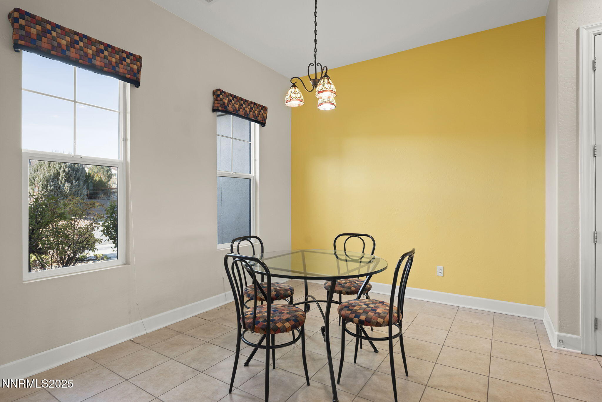 9190 Quilberry Way Reno, NV 89523 - Photo 7 of 39 a view of a dining room with furniture and a window