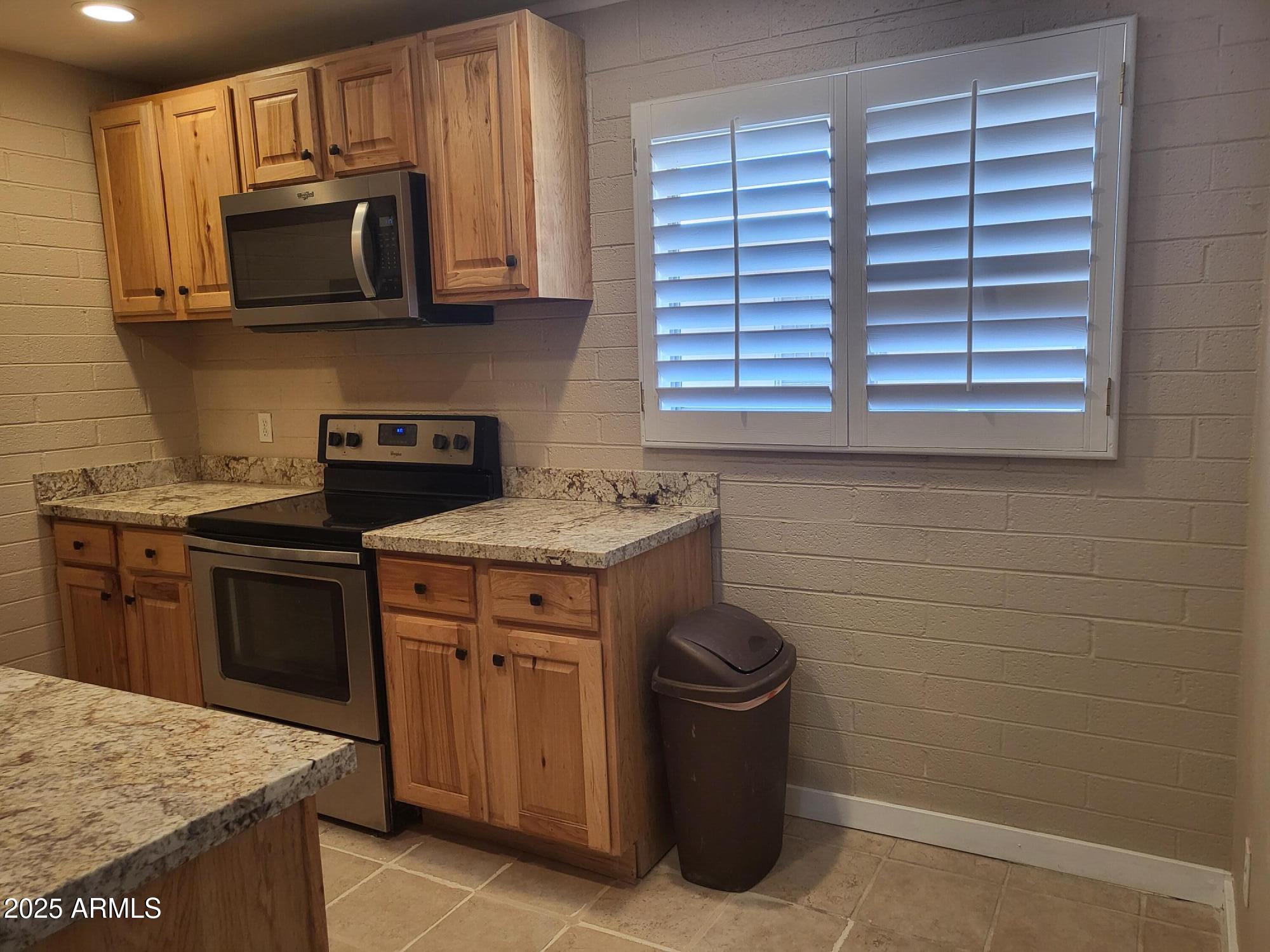 815 North Hayden Road, Unit A204 Scottsdale, AZ 85257 - Photo 7 of 27 a kitchen with a stove and a microwave