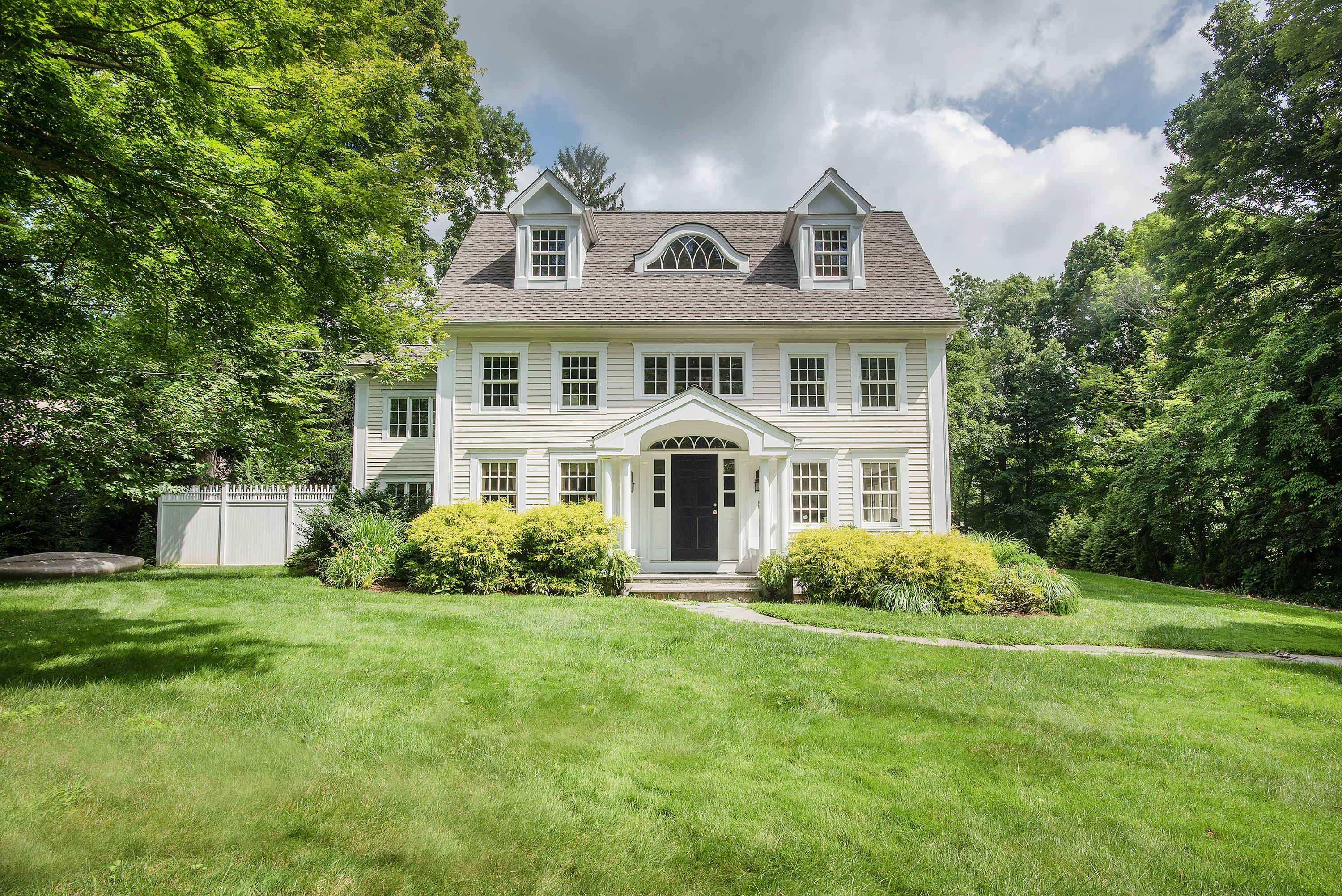 103 Jelliff Mill Road New Canaan, CT 06840 - Photo 1 of 30 a front view of a house with garden
