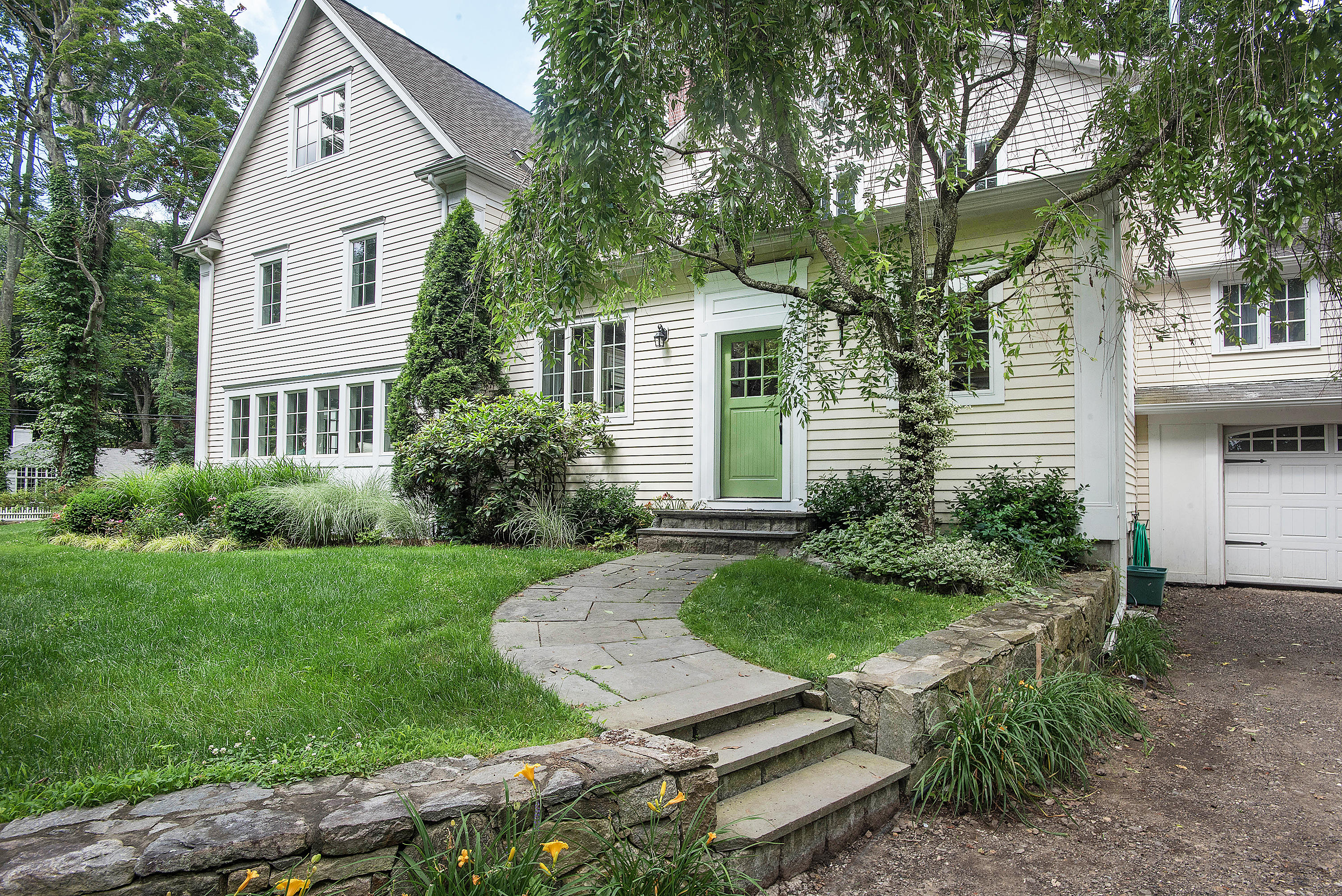 103 Jelliff Mill Road New Canaan, CT 06840 - Photo 28 of 30 a front view of a house with a yard and trees