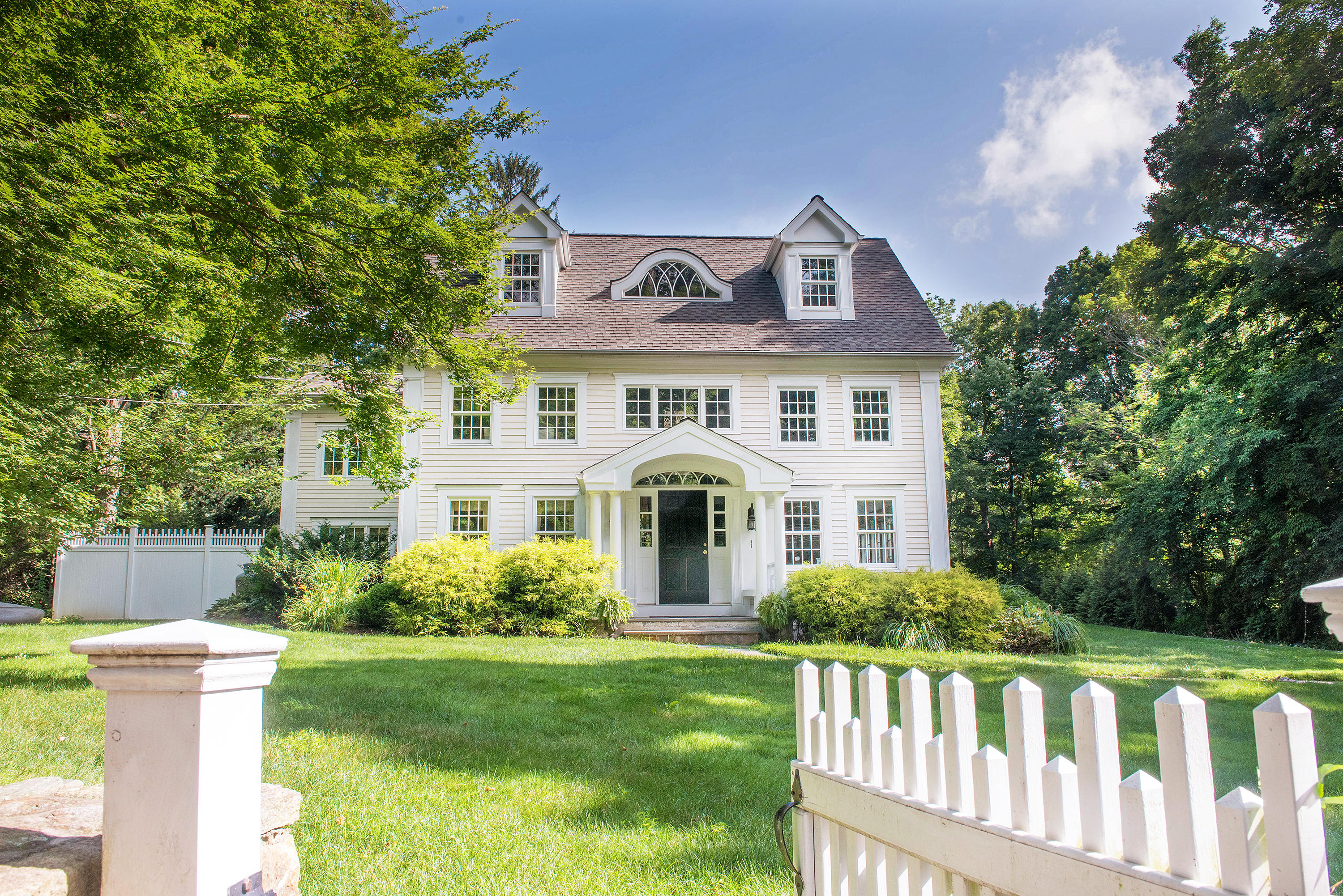 103 Jelliff Mill Road New Canaan, CT 06840 - Photo 30 of 30 a front view of a house with a garden