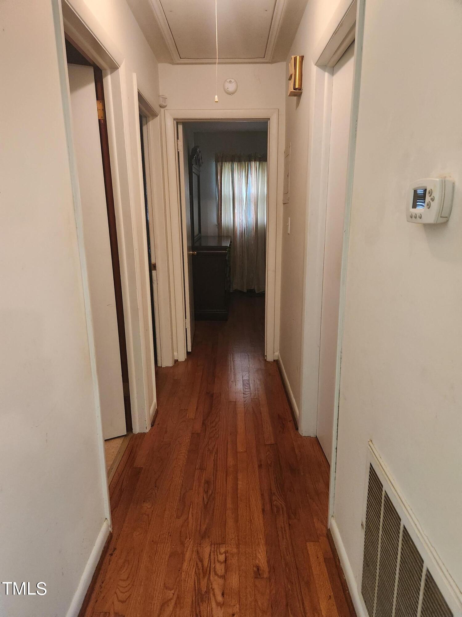 704 Donnelly Road Raleigh, NC 27610 - Photo 11 of 26 a view of a hallway with wooden floor