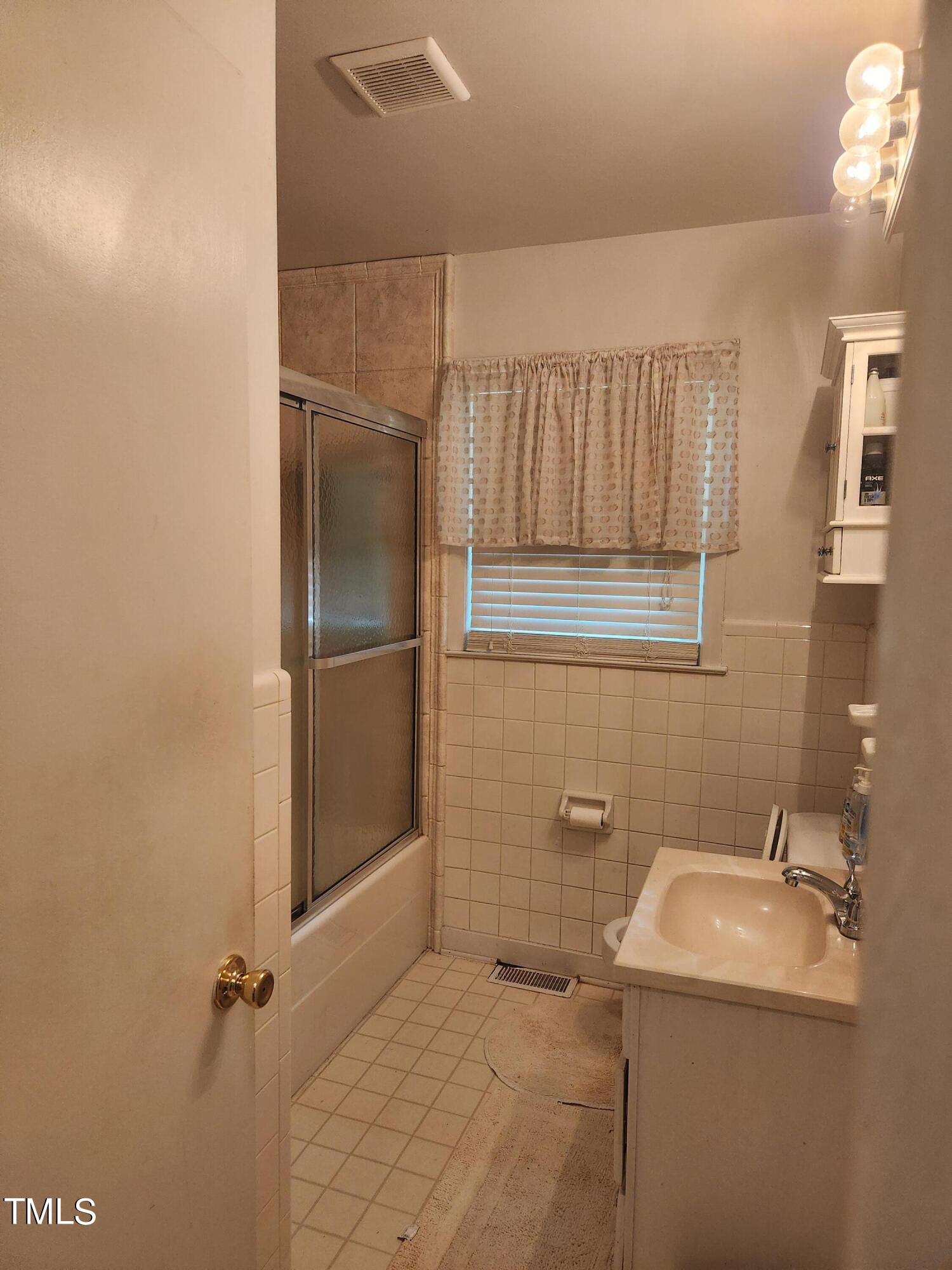 704 Donnelly Road Raleigh, NC 27610 - Photo 12 of 26 a bathroom with a sink toilet and shower