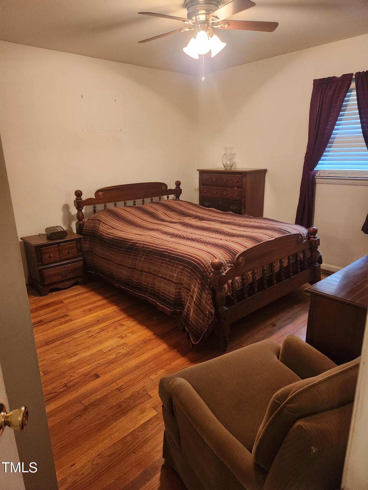 704 Donnelly Road Raleigh, NC 27610 - Photo 14 of 26 a bedroom with bed and window