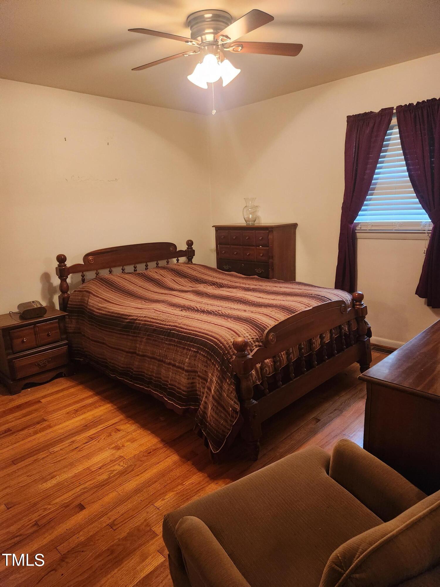 704 Donnelly Road Raleigh, NC 27610 - Photo 15 of 26 a bedroom with bed and window