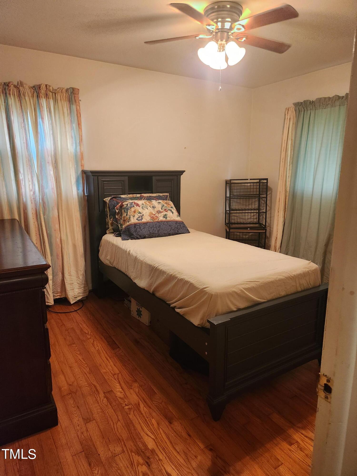 704 Donnelly Road Raleigh, NC 27610 - Photo 18 of 26 a bedroom with a bed and a chandelier
