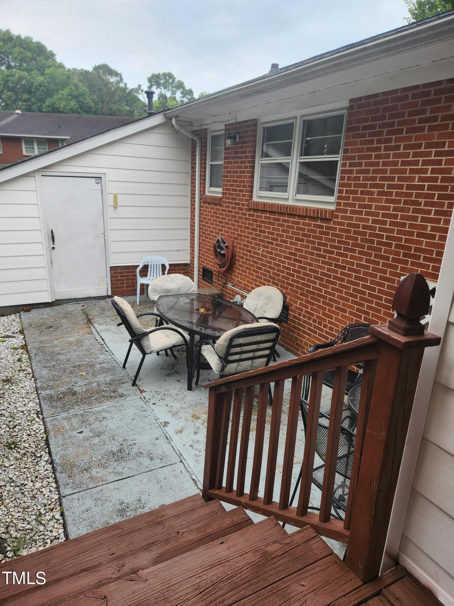 704 Donnelly Road Raleigh, NC 27610 - Photo 21 of 26 a backyard of a house with barbeque oven table and chairs