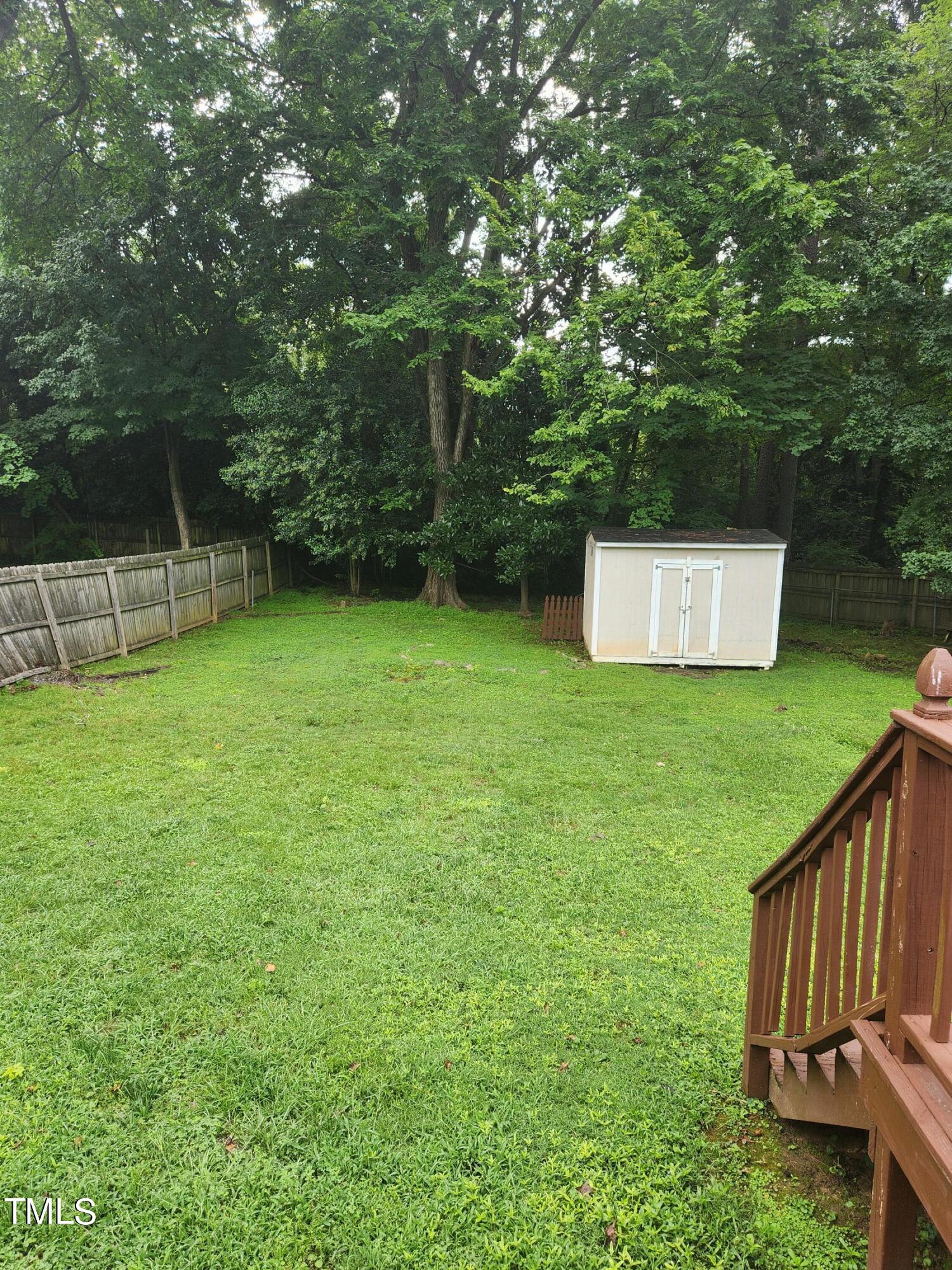 704 Donnelly Road Raleigh, NC 27610 - Photo 26 of 26 a view of a backyard with a small cabin