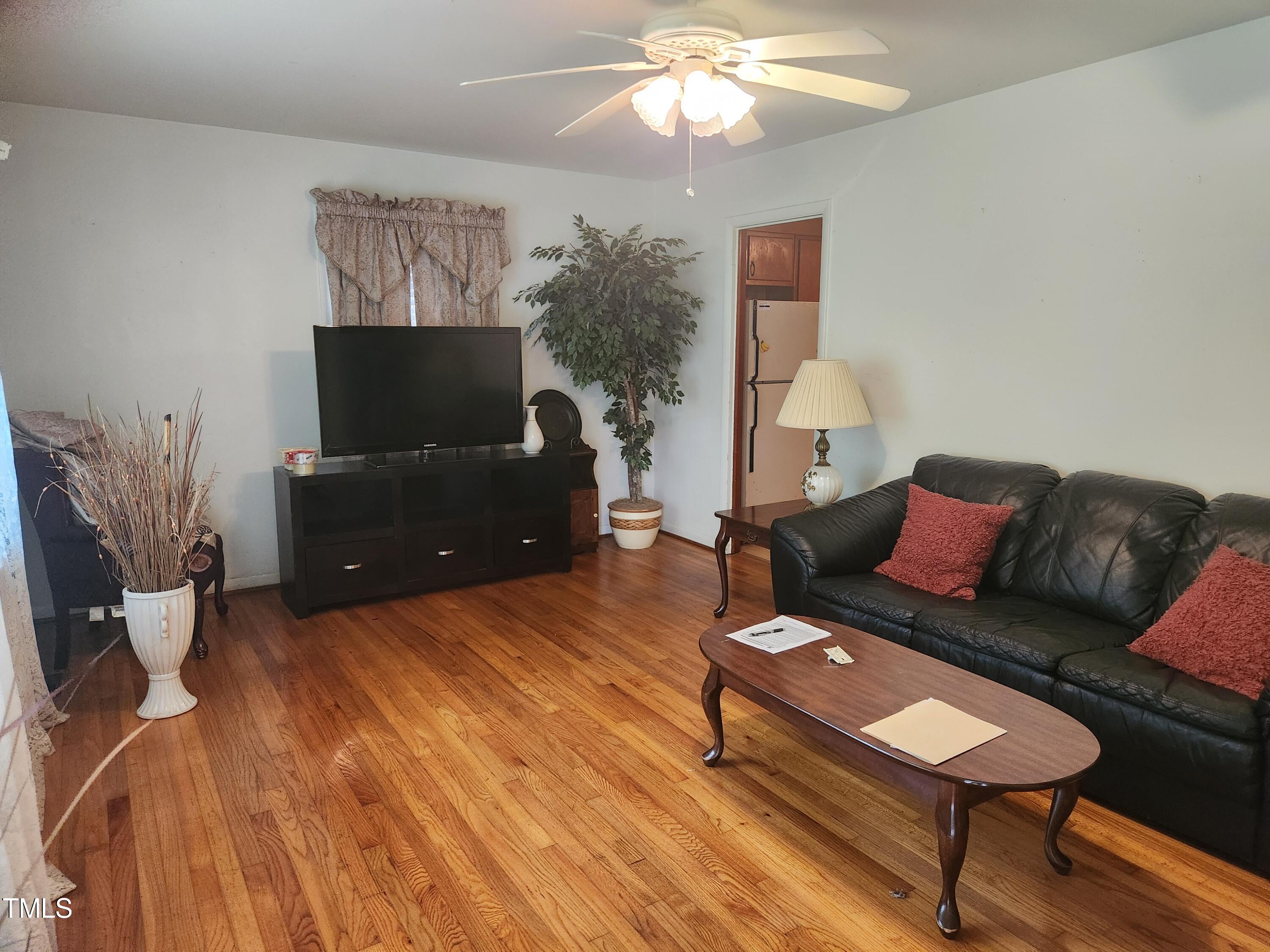 704 Donnelly Road Raleigh, NC 27610 - Photo 4 of 26 a living room with furniture and a flat screen tv