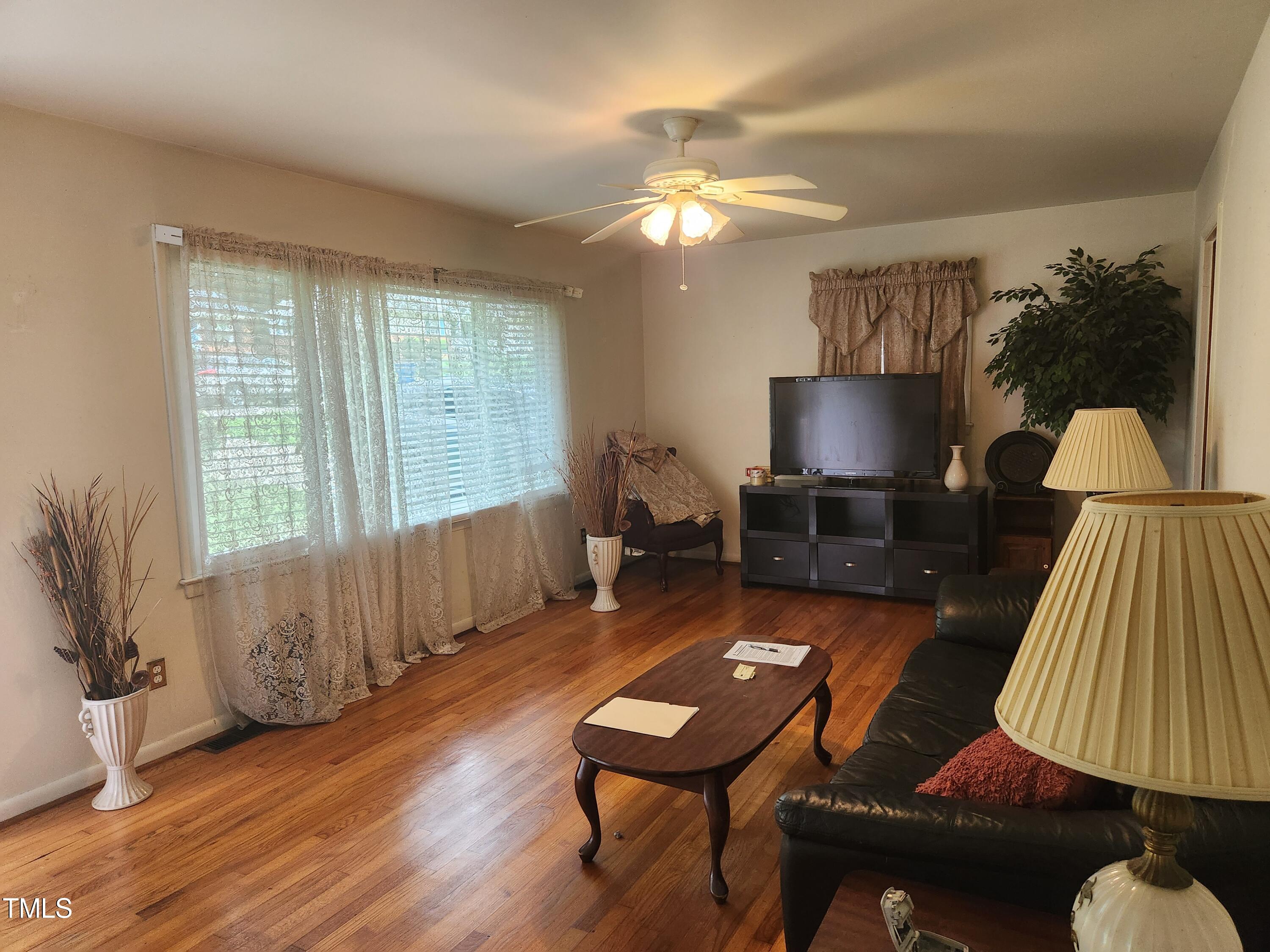 704 Donnelly Road Raleigh, NC 27610 - Photo 5 of 26 a living room with furniture and a lamp