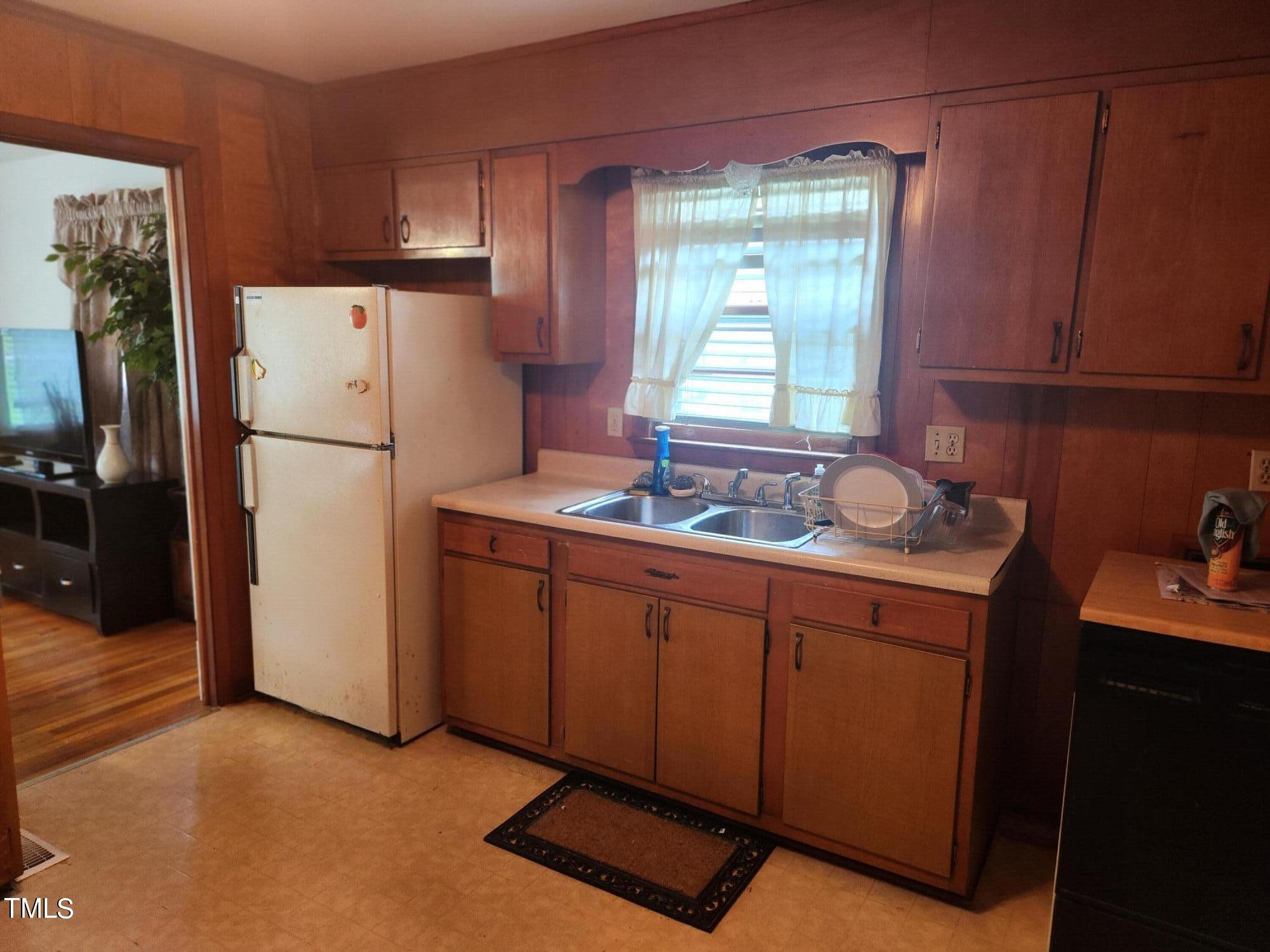 704 Donnelly Road Raleigh, NC 27610 - Photo 7 of 26 a kitchen with refrigerator cabinets and a sink