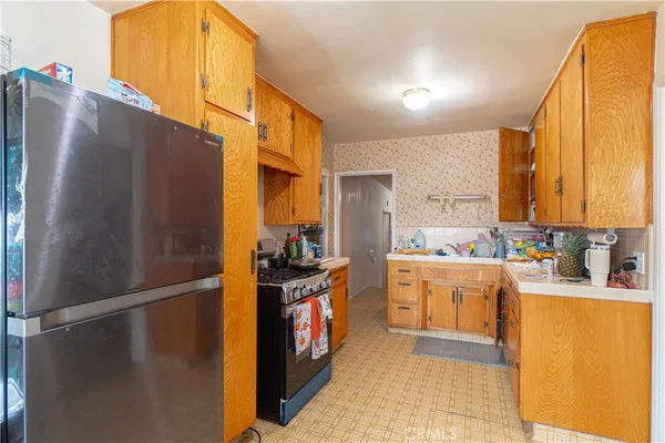 a large white kitchen with lots of counter space wooden floor and appliances
