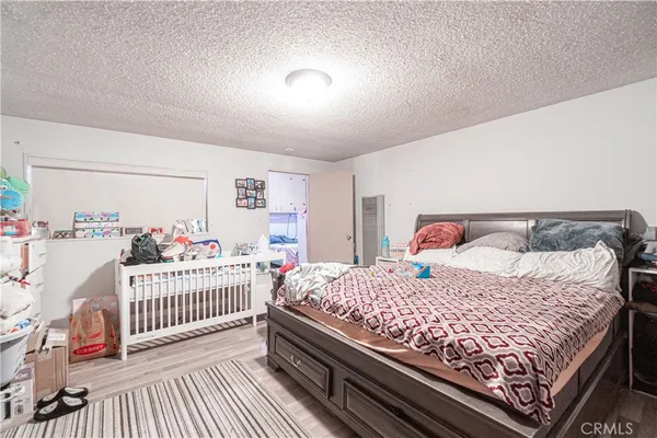 a bedroom with furniture and a wooden floor