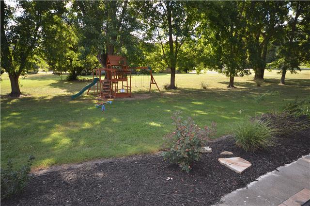 Sitting on the patio look at the awesome backyard wth mature trees