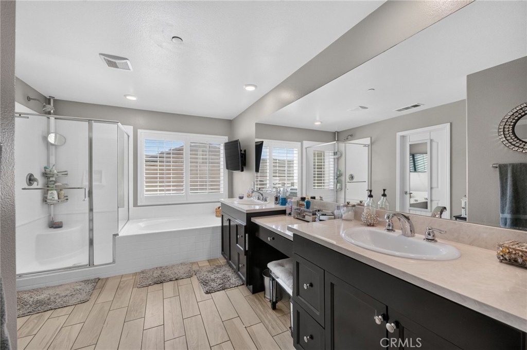 23347 Crystal Way Wildomar, CA 92595 - Photo 86 of 109 a bathroom with a sink double vanity granite tub shower and a mirror