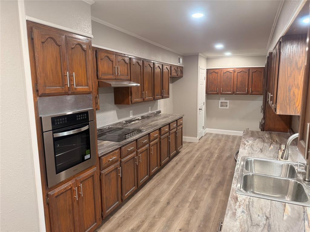 112 Myrtle Drive New Boston, TX 75570 - Photo 11 of 31 a kitchen with stainless steel appliances granite countertop a stove a sink and a refrigerator