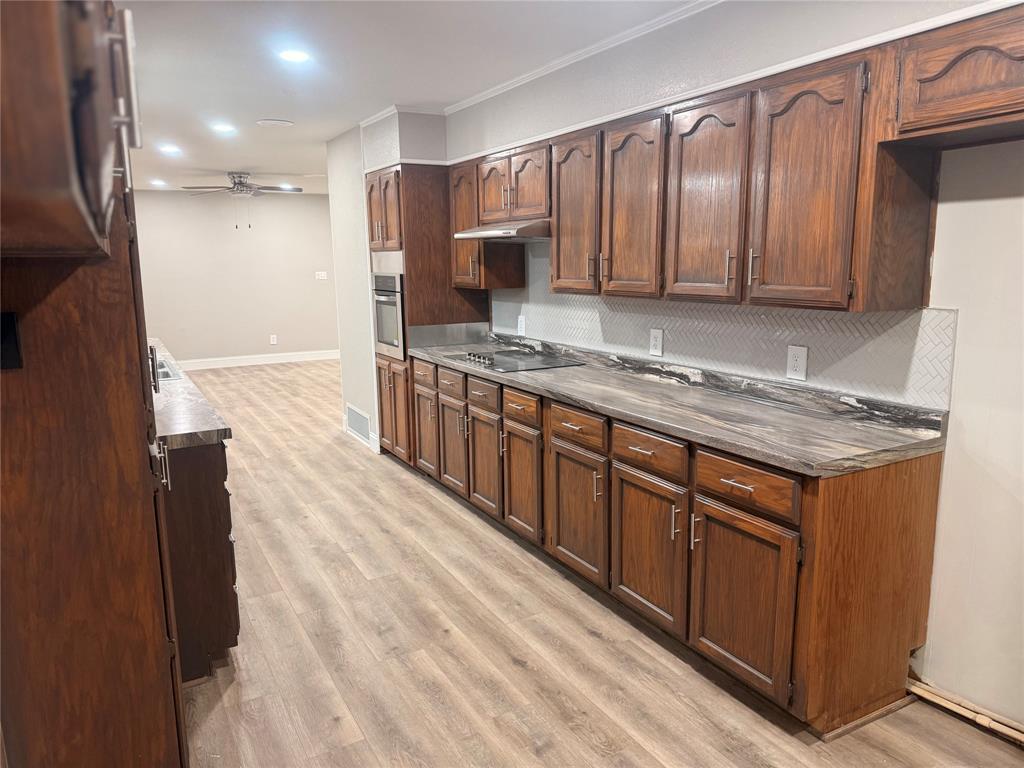 112 Myrtle Drive New Boston, TX 75570 - Photo 12 of 31 a kitchen with stainless steel appliances granite countertop a stove a sink and a refrigerator