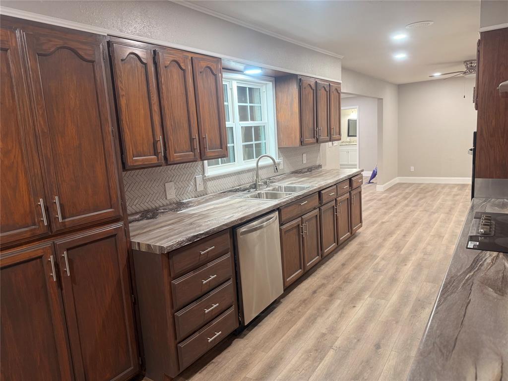 112 Myrtle Drive New Boston, TX 75570 - Photo 13 of 31 a kitchen with granite countertop a sink cabinets and wooden floor