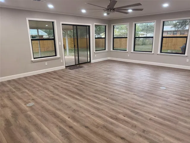a kitchen with granite countertop a sink cabinets and wooden floor
