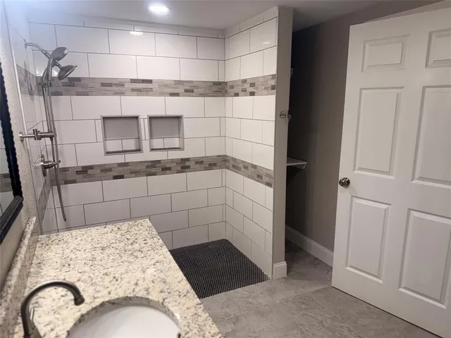 a bathroom with a sink and a shower