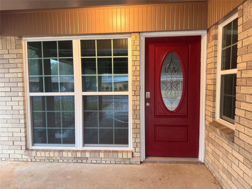 112 Myrtle Drive New Boston, TX 75570 - Photo 2 of 31 a wooden door with a window