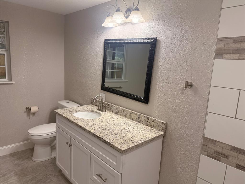 112 Myrtle Drive New Boston, TX 75570 - Photo 20 of 31 a bathroom with a granite countertop sink and a mirror