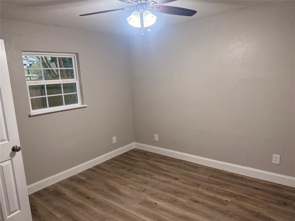 112 Myrtle Drive New Boston, TX 75570 - Photo 23 of 31 an empty room with wooden floor and windows