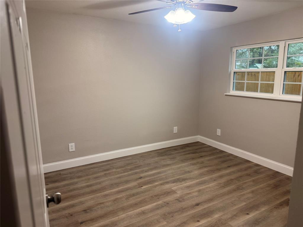 112 Myrtle Drive New Boston, TX 75570 - Photo 27 of 31 an empty room with wooden floor and windows