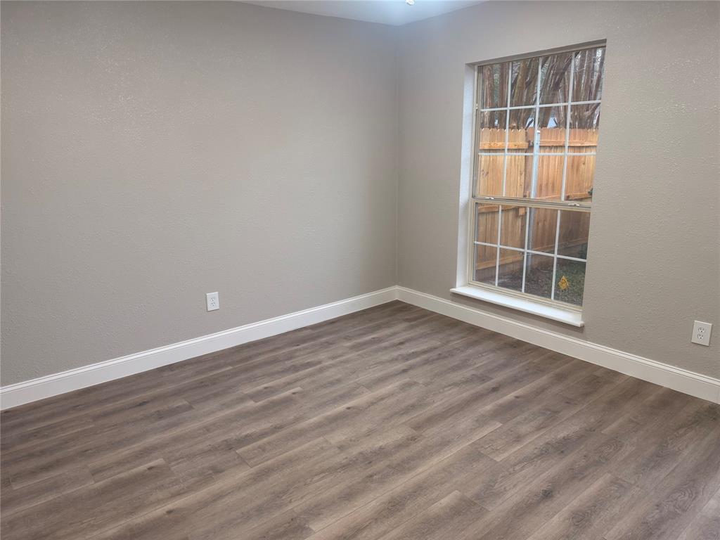112 Myrtle Drive New Boston, TX 75570 - Photo 5 of 31 an empty room with wooden floor and windows