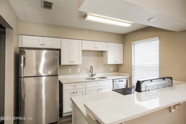 a kitchen that has a sink and a stove