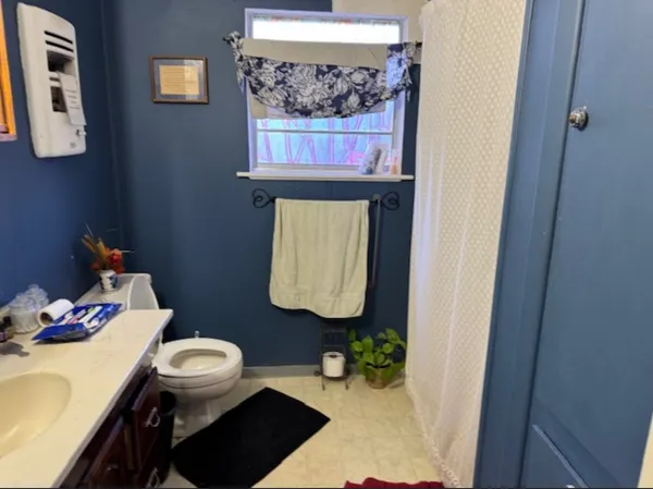 a bathroom with a sink a toilet and mirror