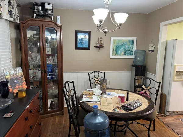 a view of a dining room with furniture and chandelier