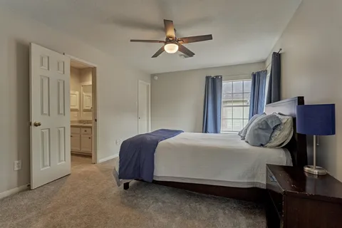 a bedroom with a bed and window