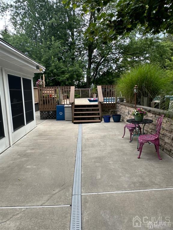 13 Parsons Road East Brunswick, NJ 08816 - Photo 13 of 39 a view of a chairs and tables in the back yard of the house