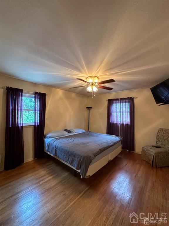 13 Parsons Road East Brunswick, NJ 08816 - Photo 22 of 39 a bedroom with a bed and wooden floor