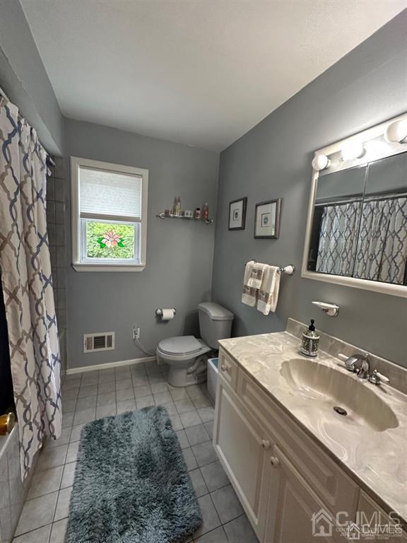 13 Parsons Road East Brunswick, NJ 08816 - Photo 23 of 39 a bathroom with a sink a toilet and a mirror