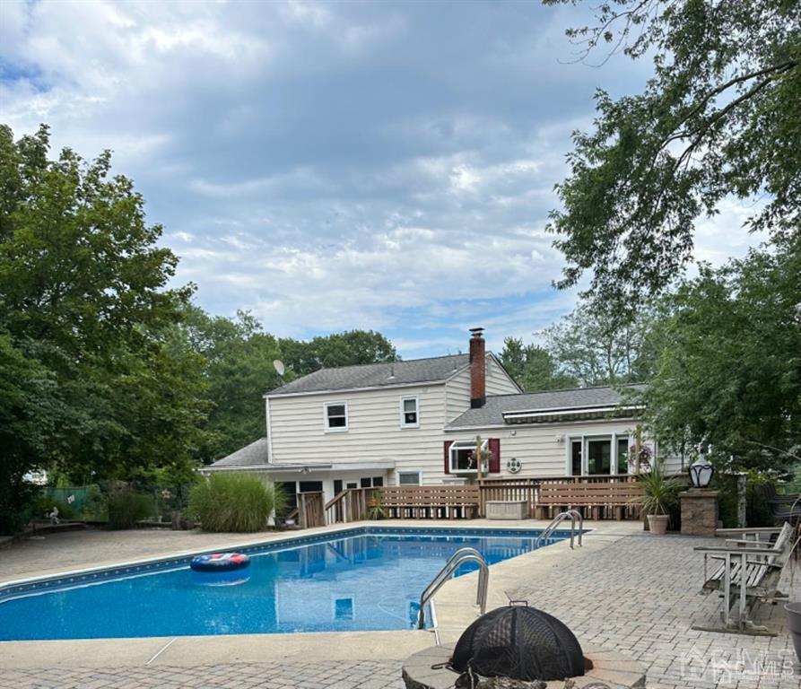 13 Parsons Road East Brunswick, NJ 08816 - Photo 10 of 39 a view of house with swimming pool and furniture