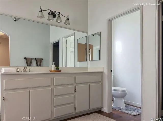 a bathroom with a toilet a sink and mirror