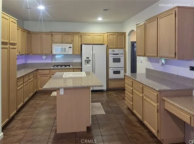 a kitchen with stainless steel appliances a stove refrigerator sink and cabinets