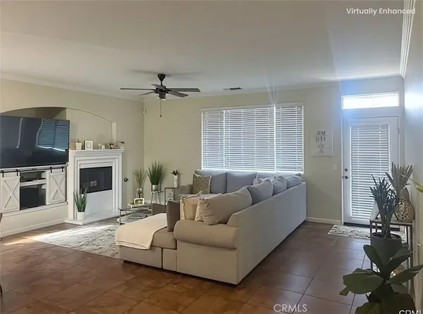 a living room with furniture a large window and a fireplace