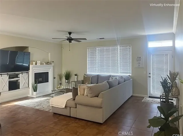 a living room with furniture a large window and a fireplace