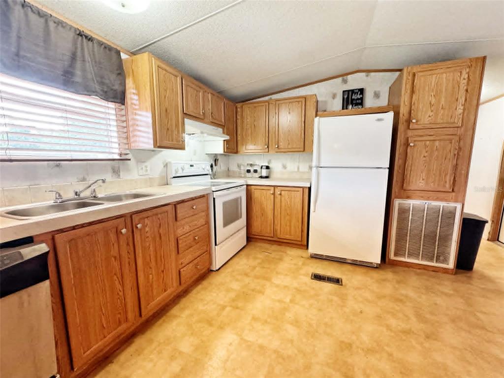 612 Morgan Road Winter Haven, FL 33880 - Photo 7 of 38 a kitchen with stainless steel appliances a refrigerator sink and cabinets