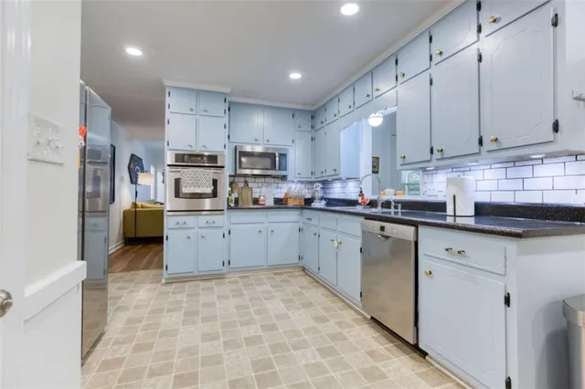 a kitchen with stainless steel appliances cabinets a sink and a counter