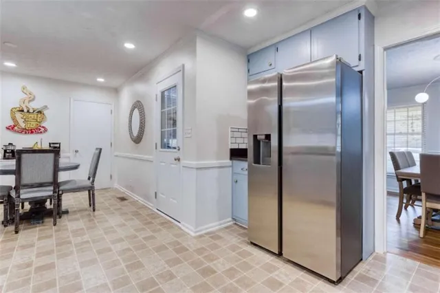 a kitchen with stainless steel appliances granite countertop a refrigerator and a sink