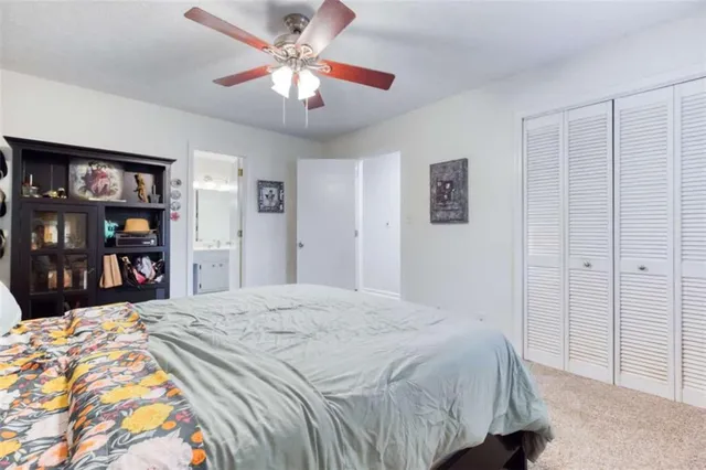 a bedroom with a bed and a book shelf