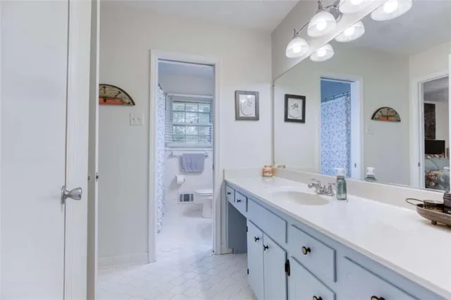 a bathroom with a sink a mirror and a shower