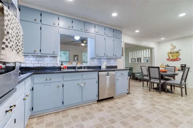 a kitchen with cabinets and chairs