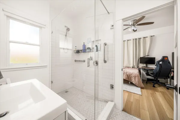 a bathroom with a sink a toilet and a shower