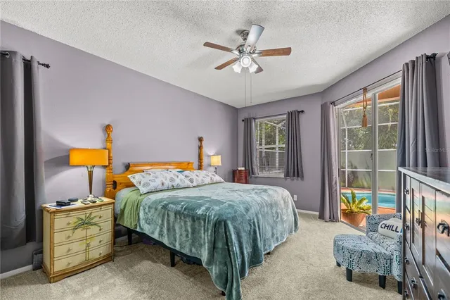 a bedroom with a bed a chandelier and a window